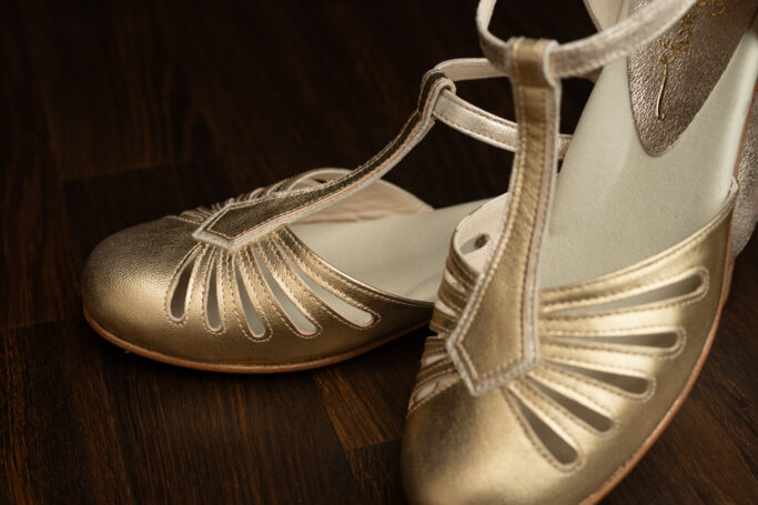 Riviera Flat Gold, a vintage sandal in a soft, warm gold tone with padded footbed and leather sole and heel